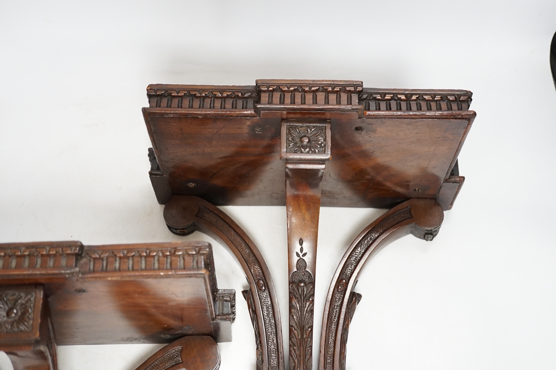 A pair of Edwardian Sheraton Revival mahogany wall brackets, 28cm high. Condition - fair to good